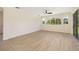 Bright bedroom with hardwood flooring, lots of natural light, and a sliding glass door at 7727 Heyward Cir, University Park, FL 34201