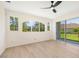 Bright bedroom with hardwood flooring, large windows, and sliding glass doors at 7727 Heyward Cir, University Park, FL 34201
