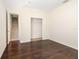 Wood-floored bedroom with a walk-in closet and a door to the hallway at 7727 Heyward Cir, University Park, FL 34201