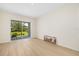 Bright room featuring light wood-look floors and glass patio doors at 7727 Heyward Cir, University Park, FL 34201