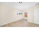 Spacious bedroom with three accent windows and light wood floors at 7727 Heyward Cir, University Park, FL 34201
