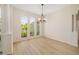 Well-lit dining area with luxury vinyl floors, large windows, and neutral walls at 7727 Heyward Cir, University Park, FL 34201
