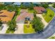 Beautiful home with manicured lawn, mature trees, and long driveway at 7727 Heyward Cir, University Park, FL 34201