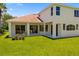 Back exterior featuring a covered patio and manicured lawn at 7727 Heyward Cir, University Park, FL 34201