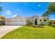 Stunning single-story home with lush landscaping, beautiful lawn, and a three-car garage at 7727 Heyward Cir, University Park, FL 34201