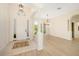 Bright foyer with high ceilings, large windows, and light-colored tile flooring at 7727 Heyward Cir, University Park, FL 34201