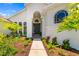Inviting home entrance with a beautifully landscaped front yard and arched windows at 7727 Heyward Cir, University Park, FL 34201