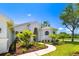 Gorgeous home with a winding sidewalk, mature trees, and beautiful garden at 7727 Heyward Cir, University Park, FL 34201