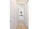 Bright hallway leading to a bathroom with a soaking tub and transom window at 7727 Heyward Cir, University Park, FL 34201