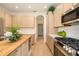 Bright kitchen showcasing an island, stainless steel appliances, and plenty of storage at 7727 Heyward Cir, University Park, FL 34201