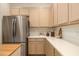 Kitchen with stainless steel refrigerator, lots of counterspace and cabinets at 7727 Heyward Cir, University Park, FL 34201