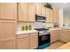 Modern kitchen featuring ample cabinet space, a stainless steel microwave and range at 7727 Heyward Cir, University Park, FL 34201