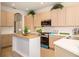 Modern kitchen with an island, and stainless steel appliances at 7727 Heyward Cir, University Park, FL 34201