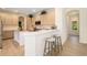 Modern kitchen with ample counter seating and bar and stainless steel appliances at 7727 Heyward Cir, University Park, FL 34201