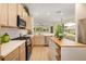 Bright and spacious kitchen with stainless steel appliances, white countertops, and luxury vinyl floors at 7727 Heyward Cir, University Park, FL 34201
