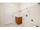 Functional laundry room features a utility sink, storage cabinet, and wire shelving for organization at 7727 Heyward Cir, University Park, FL 34201