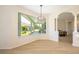 Bright living room with hardwood flooring, a modern chandelier, and lots of natural light at 7727 Heyward Cir, University Park, FL 34201