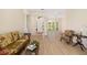Bright living room featuring high ceilings, an abundance of natural light, and luxury vinyl floors at 7727 Heyward Cir, University Park, FL 34201