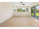 Spacious living room with hardwood flooring, large windows and sliding door at 7727 Heyward Cir, University Park, FL 34201
