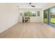 Spacious living room with hardwood flooring, large windows and sliding glass doors at 7727 Heyward Cir, University Park, FL 34201