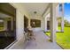Enjoy the outdoor living space with a covered patio perfect for relaxing or entertaining guests with views of the spacious lawn at 7727 Heyward Cir, University Park, FL 34201