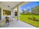 Inviting covered patio featuring a seating area with views of the lawn, creating an ideal outdoor living space at 7727 Heyward Cir, University Park, FL 34201
