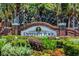 Welcome to University Place displayed on brick sign with colorful flower beds at 7727 Heyward Cir, University Park, FL 34201