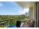 Comfortable balcony with seating and scenic views of the water and tropical landscape at 800 N Tamiami Trl # 405, Sarasota, FL 34236