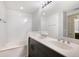 Bright bathroom featuring a double vanity, and a soaking tub with a tiled backsplash at 800 N Tamiami Trl # 405, Sarasota, FL 34236