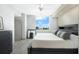 Well-lit main bedroom with hardwood floors, neutral tones, and an ocean view at 800 N Tamiami Trl # 405, Sarasota, FL 34236