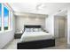 Spacious main bedroom with neutral tones and great lighting, ceiling fan and an ensuite bath at 800 N Tamiami Trl # 405, Sarasota, FL 34236