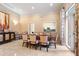 Bright dining room featuring a large table with patterned chairs and stylish accents at 800 N Tamiami Trl # 405, Sarasota, FL 34236