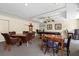 Well-lit game room with multiple tables for cards, billiards, and other entertainment at 800 N Tamiami Trl # 405, Sarasota, FL 34236