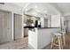 Modern kitchen with stainless steel appliances, dark countertops, and barstool seating at 800 N Tamiami Trl # 405, Sarasota, FL 34236
