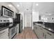 Efficient kitchen featuring stainless steel appliances, sleek countertops, and modern hardware at 800 N Tamiami Trl # 405, Sarasota, FL 34236