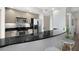 Updated kitchen with stainless steel appliances, dark countertops, and barstool seating at 800 N Tamiami Trl # 405, Sarasota, FL 34236