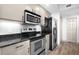Efficient kitchen featuring stainless steel appliances, sleek countertops, and modern hardware at 800 N Tamiami Trl # 405, Sarasota, FL 34236