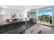 Entertain in a bright kitchen with stainless appliances, dark counters and an ocean view at 800 N Tamiami Trl # 405, Sarasota, FL 34236