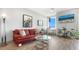 Inviting living room with a stylish sofa, glass table, modern lighting, and picturesque views from the large windows at 800 N Tamiami Trl # 405, Sarasota, FL 34236