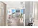 Bright living room featuring water views from large windows, sleek furniture, and modern decor at 800 N Tamiami Trl # 405, Sarasota, FL 34236