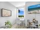 Charming sitting area with a desk, bar cart, and serene views from the window, perfect for relaxation and productivity at 800 N Tamiami Trl # 405, Sarasota, FL 34236