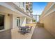 Private outdoor patio featuring stylish wrought iron furniture, ideal for relaxation and outdoor dining at 800 N Tamiami Trl # 405, Sarasota, FL 34236
