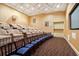 Home theater featuring tiered seating and a large screen for immersive entertainment at 800 N Tamiami Trl # 405, Sarasota, FL 34236