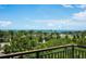 Beautiful waterfront view with palm trees and green foliage from the property at 800 N Tamiami Trl # 405, Sarasota, FL 34236