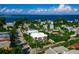 Bright aerial view of luxury property among lush landscaping with blue water views under a sunny sky at 804 N Shore Dr, Anna Maria, FL 34216