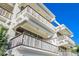Exterior view of multiple balconies with wooden railings and stylish lighting at 804 N Shore Dr, Anna Maria, FL 34216