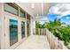 Exterior balcony showing tile flooring, privacy fence, and access to the interior at 804 N Shore Dr, Anna Maria, FL 34216