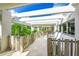 A large, covered balcony showcasing tile floors and natural wooden railings at 804 N Shore Dr, Anna Maria, FL 34216
