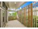 A sunlit balcony showing privacy fencing and tile flooring at 804 N Shore Dr, Anna Maria, FL 34216