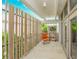 A light and airy balcony featuring an orange chair and a modern light wood fence at 804 N Shore Dr, Anna Maria, FL 34216